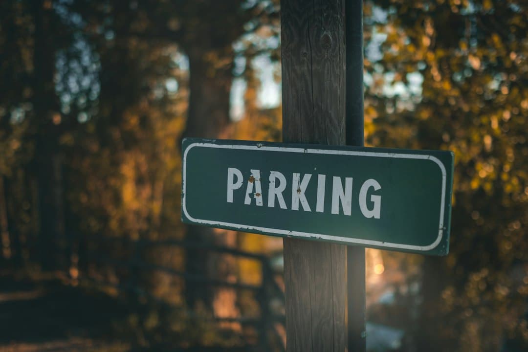a green parking sign sitting on top of a wooden pole — Photo by Marcel Fagin on Unsplash