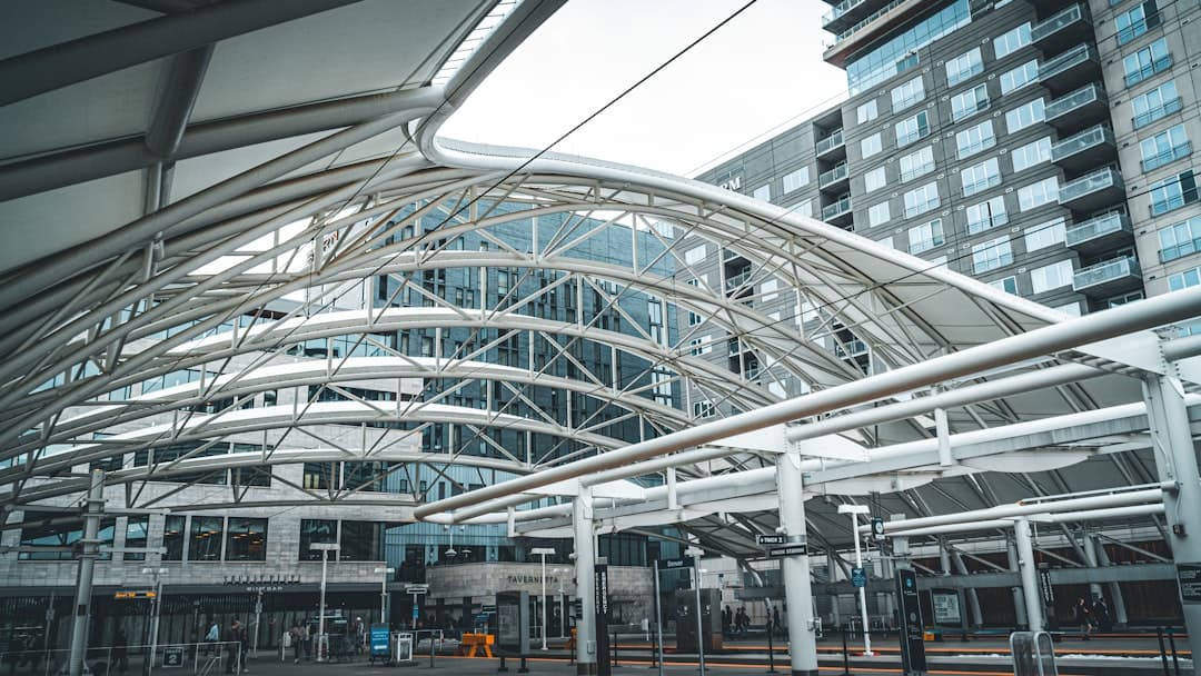 a train station with a large building in the background — Photo by Cullen Carter on Unsplash