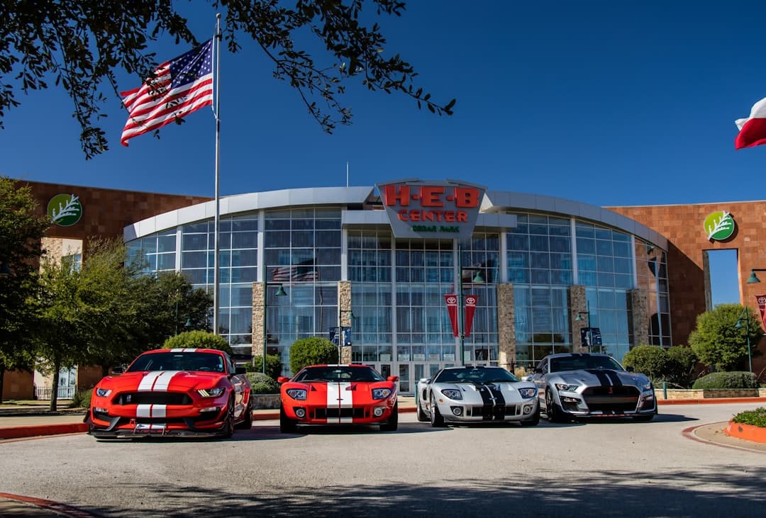 three cars parked in front of white building during daytime — Photo by Wes Tindel on Unsplash