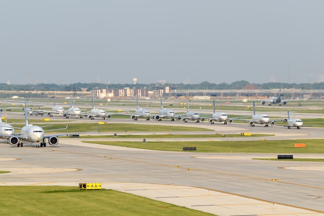 a group of airplanes parked on an airport runway — Photo by David Syphers on Unsplash