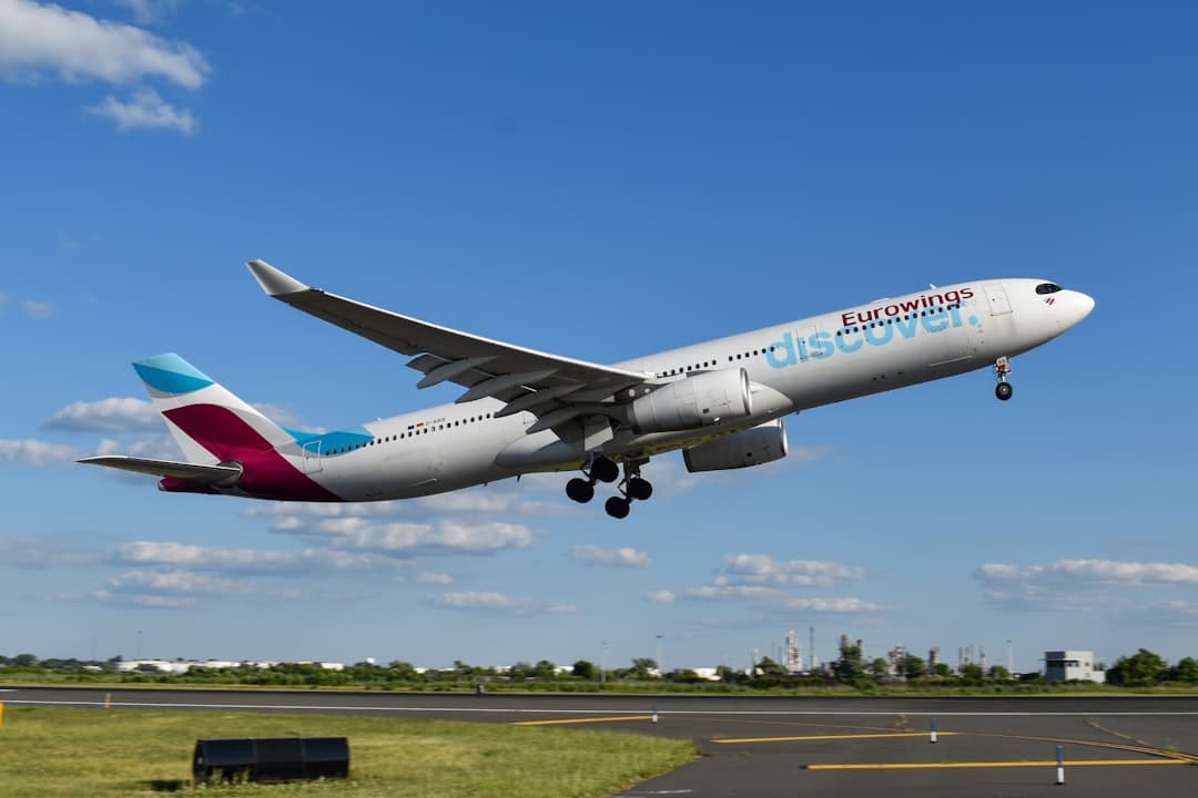A large passenger jet taking off from an airport runway — Photo by David Syphers on Unsplash