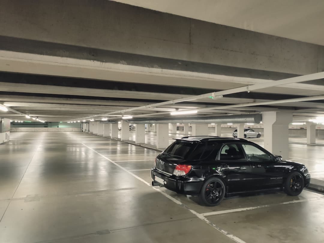 black suv in a parking lot — Photo by Adrien Fu on Unsplash