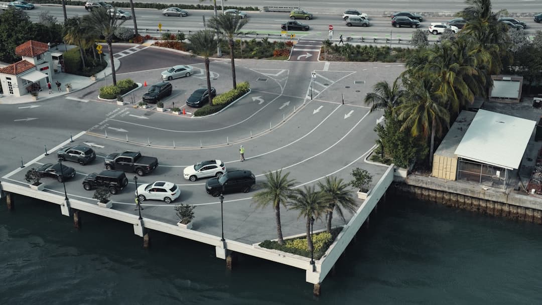 an aerial view of a parking lot next to the ocean — Photo by Dennis Zhang on Unsplash