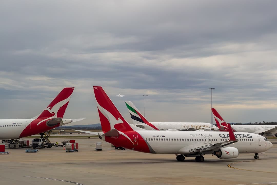 Several qantas airplanes parked at an airport. — Photo by Jošua Bird on Unsplash