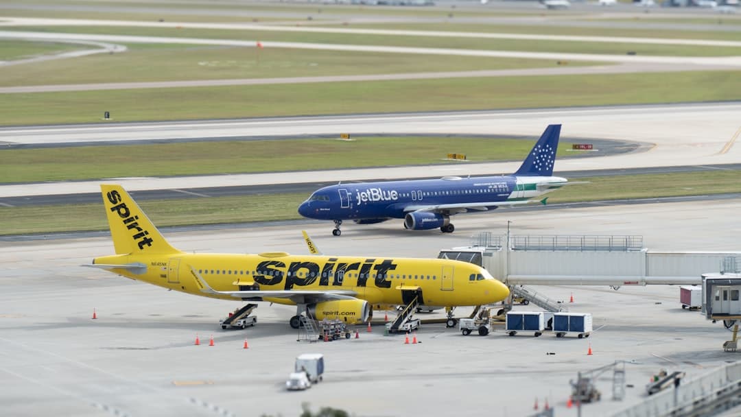 a yellow and blue jet airliner sitting on top of an airport tarmac — Photo by Hans Dorries on Unsplash