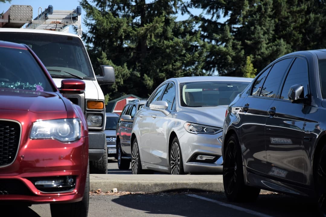 a row of parked cars on a city street — Photo by fr0ggy5 on Unsplash
