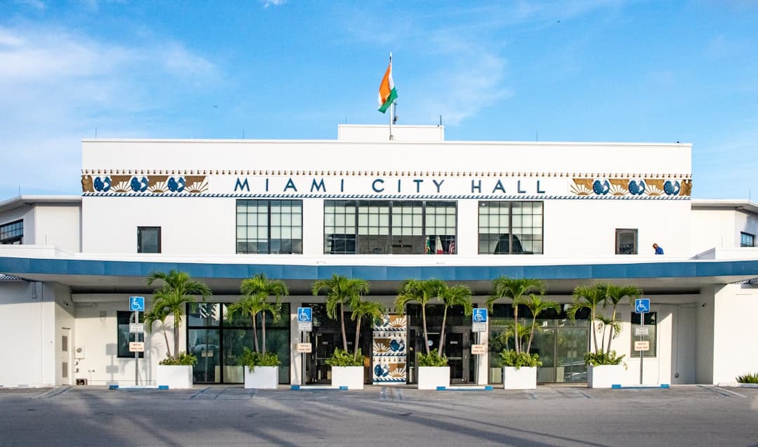 A large white building with a flag on top of it — Photo by Zoshua Colah on Unsplash