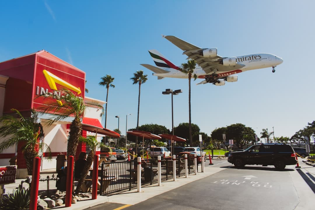 an airplane is flying over a mcdonald's restaurant — Photo by Lukas Souza on Unsplash