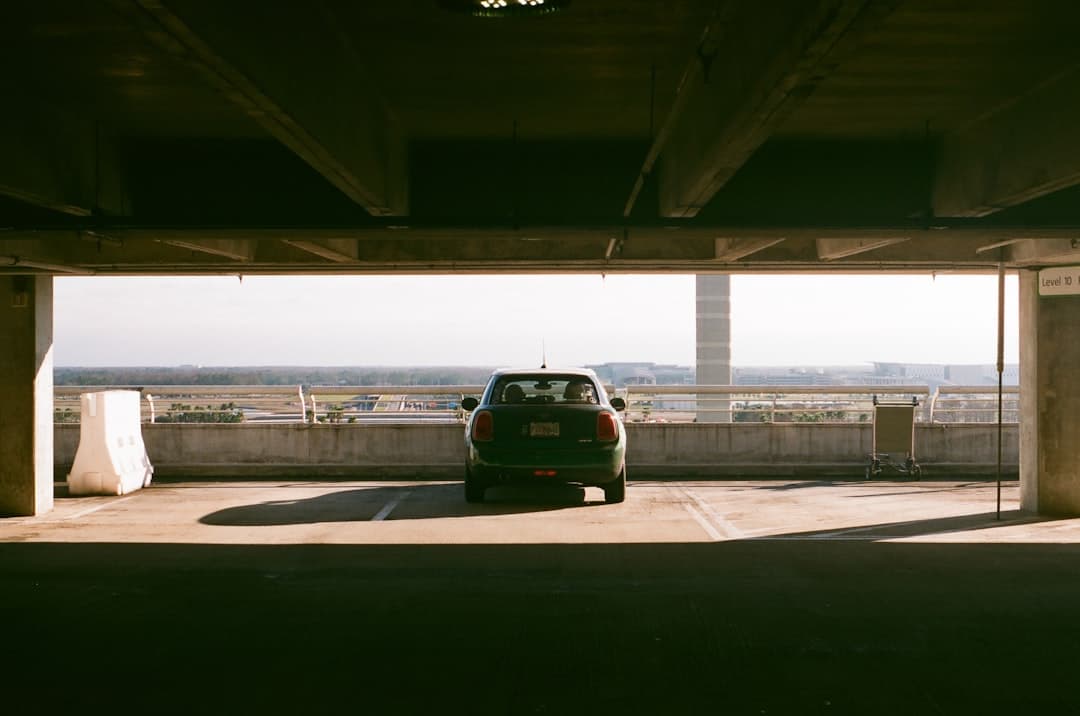 a green car parked under a bridge — Photo by Ikuna on Unsplash