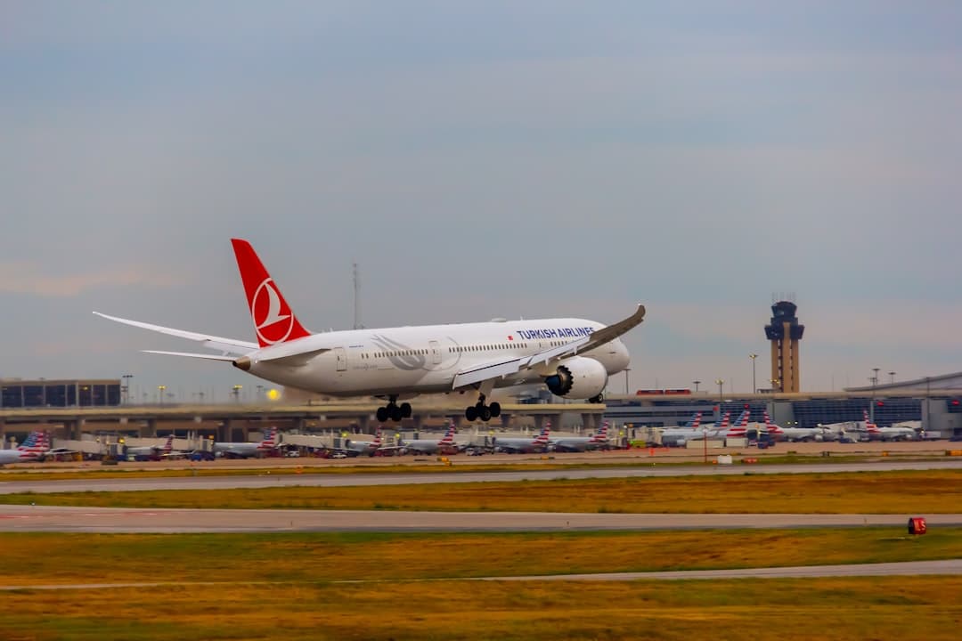 A large jetliner taking off from an airport runway — Photo by Izyan Sultanali on Unsplash