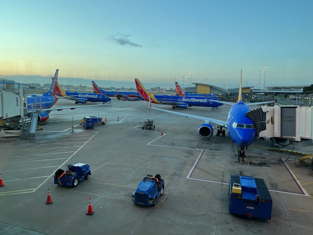 a group of airplanes parked on top of an airport tarmac — Photo by Calvin L on Unsplash