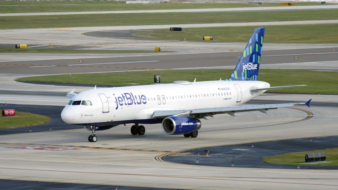 a jetblue airplane on a runway at an airport — Photo by Hans Dorries on Unsplash
