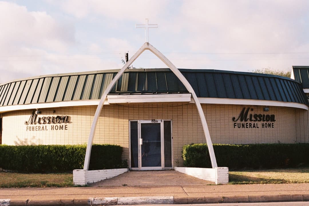 Mission funeral home building with arched entrance — Photo by Sasha Matveeva on Unsplash