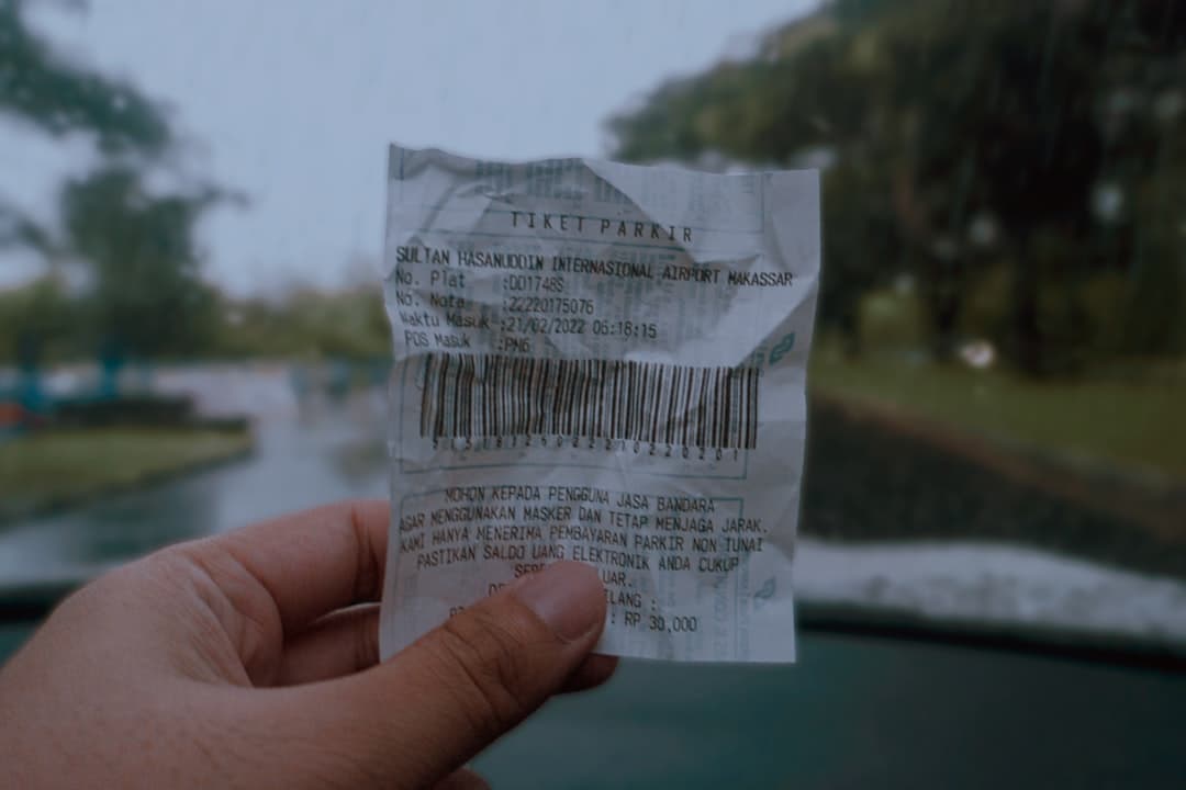a hand holding a piece of paper with a bar code on it — Photo by Am on Unsplash
