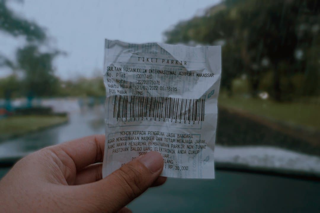 a hand holding a piece of paper with a bar code on it — Photo by Am on Unsplash