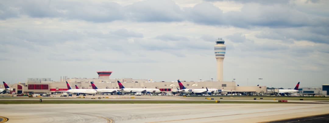 an airport with several planes parked on the tarmac — Photo by Scott Fillmer on Unsplash
