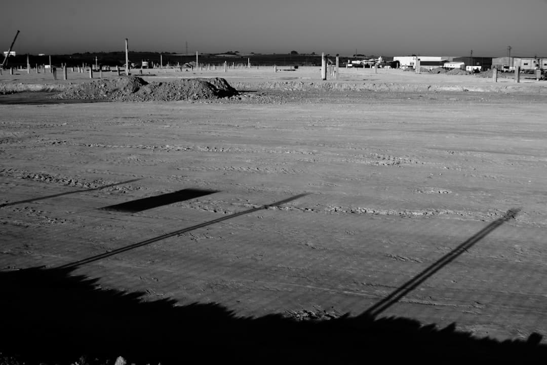 Barren field with long shadows under a clear sky. — Photo by Jose Manuel Esp on Unsplash