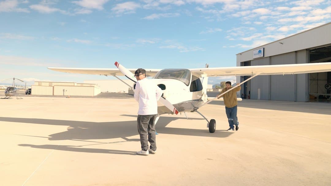 Two people near a small airplane on tarmac — Photo by Horizon flights on Unsplash