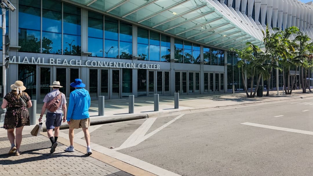 Three people walking in front of a building — Photo by Zoshua Colah on Unsplash