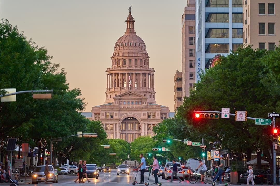 a large building towers over Texas State Capitol — Photo by Justin Wallace on Unsplash