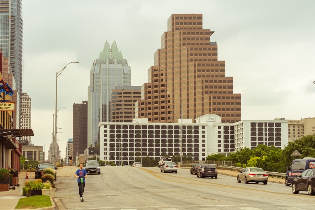cars passing by buildings during daytime — Photo by Avi Werde on Unsplash