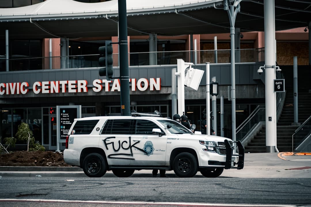 white suv parked near building during daytime — Photo by Colin Lloyd on Unsplash