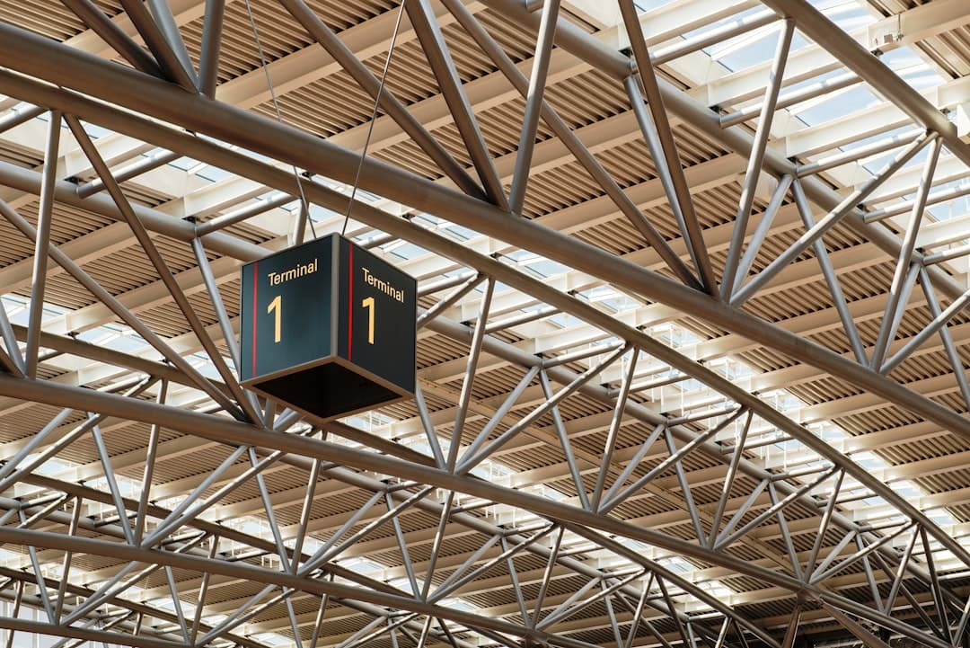 Terminal 1 sign hanging from metal structure — Photo by Wolfgang Weiser on Unsplash