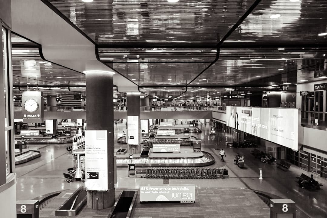 a black and white photo of a train station — Photo by Jon Champaigne on Unsplash