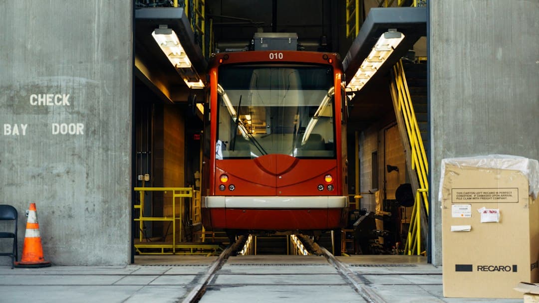 red train in between gray concrete wall — Photo by Mike Ackerman on Unsplash