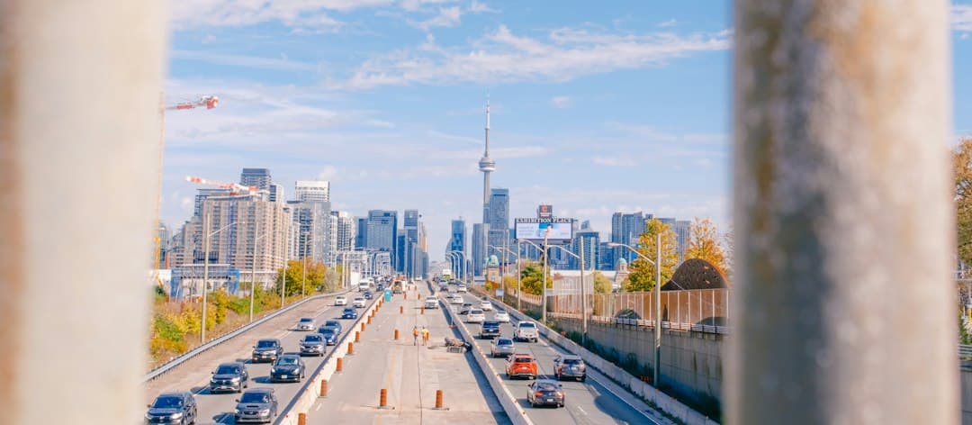 Traffic on highway with city skyline in background — Photo by Jim Luo on Unsplash