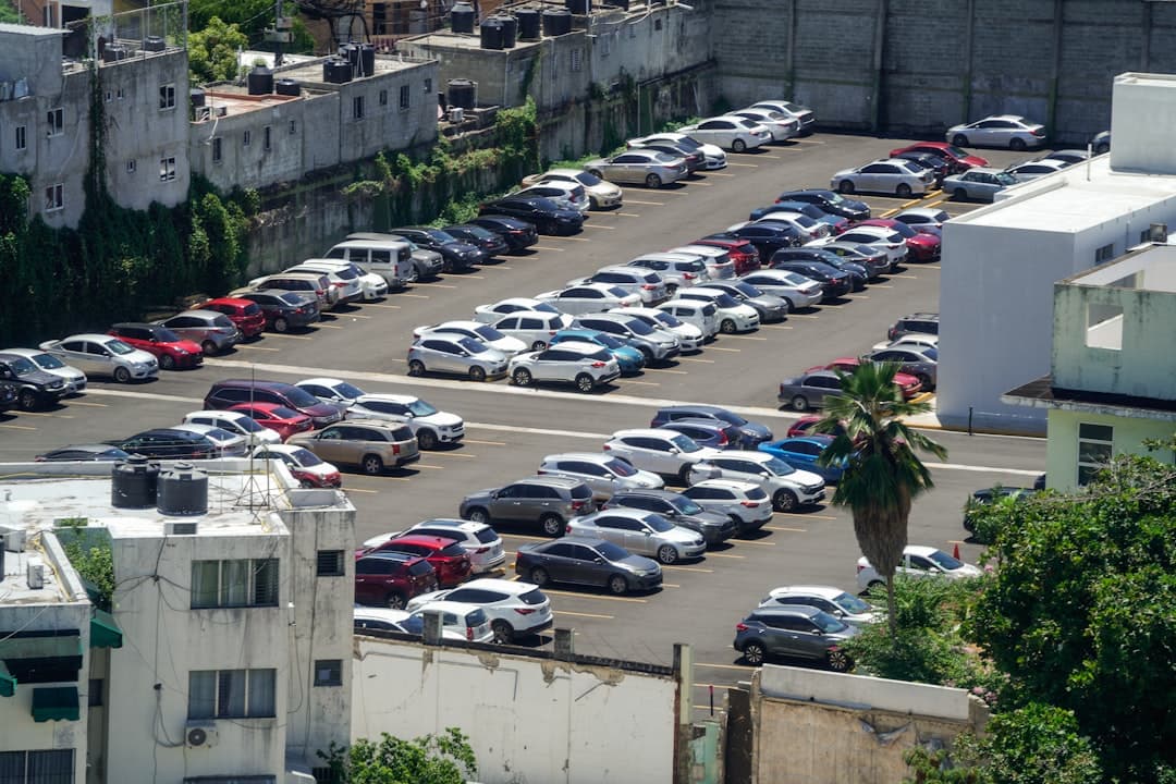 A parking lot filled with lots of parked cars — Photo by Aldward Castillo on Unsplash