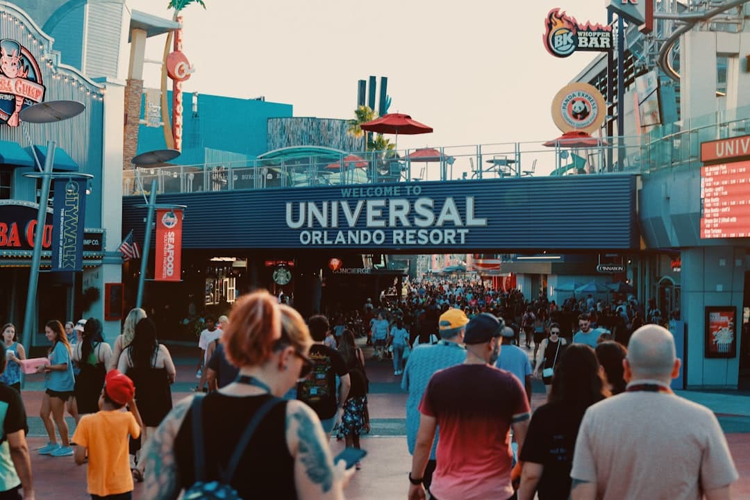 a crowd of people walking down a street next to a building — Photo by Josh Rich on Unsplash