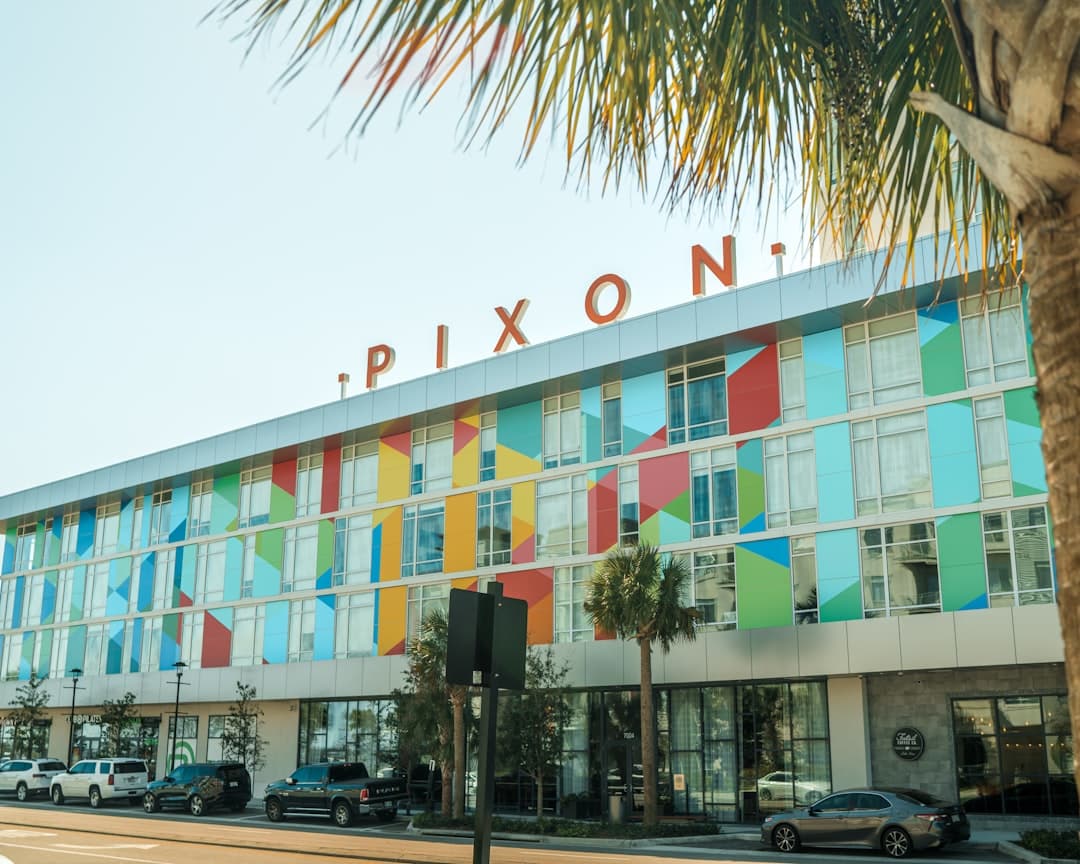 a large multicolored building with a palm tree in front of it — Photo by Eric Ardito on Unsplash