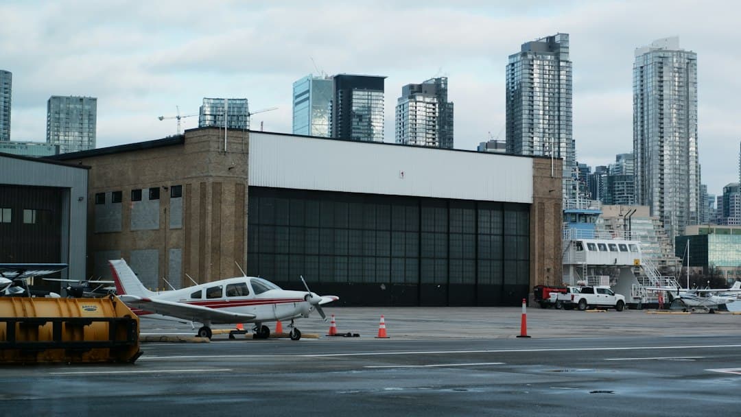 a small plane parked in front of a large building — Photo by Chels on Unsplash