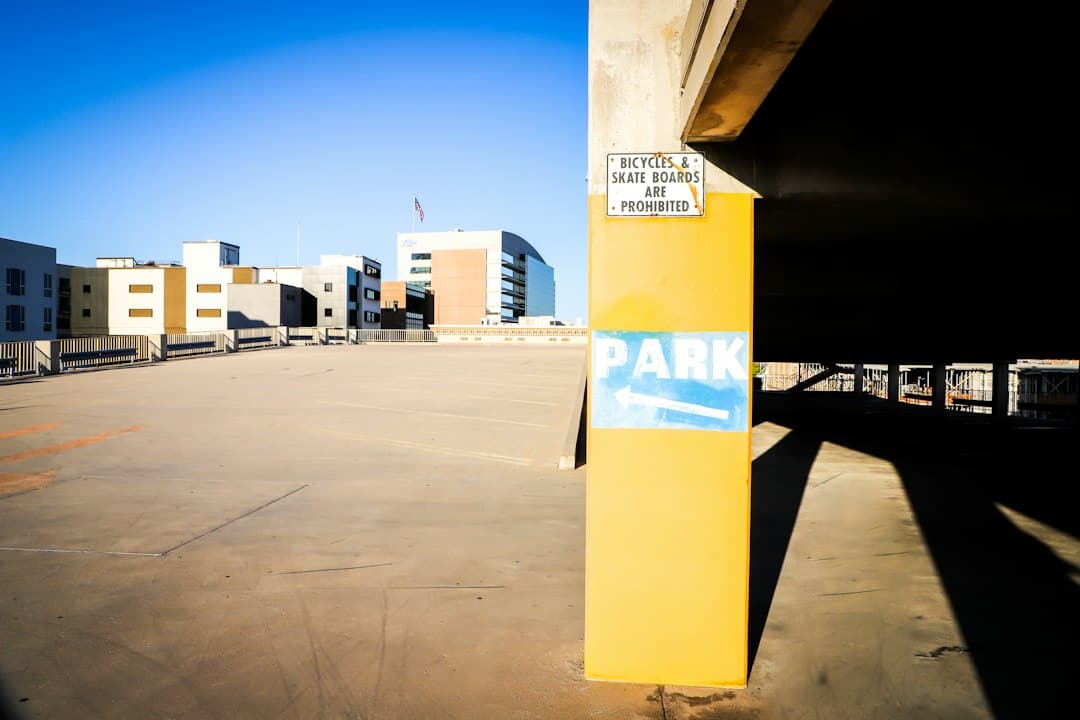yellow and white post near white and brown building during daytime — Photo by Frankie Lopez on Unsplash