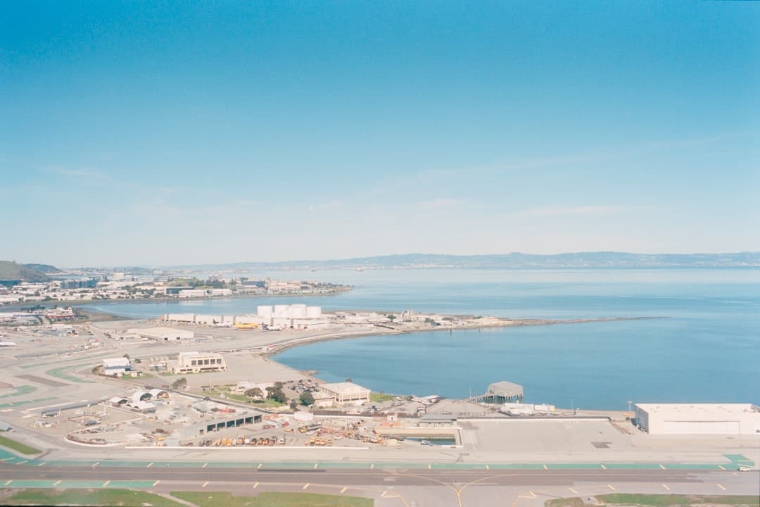 Aerial view of a coastal town and water. — Photo by realfish on Unsplash