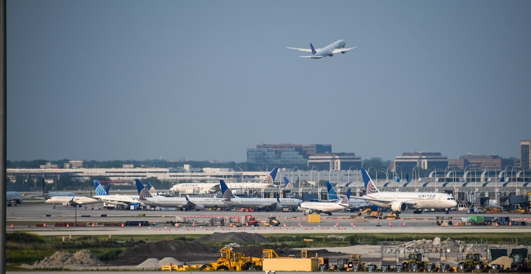 a large jetliner flying over an airport runway — Photo by David Syphers on Unsplash