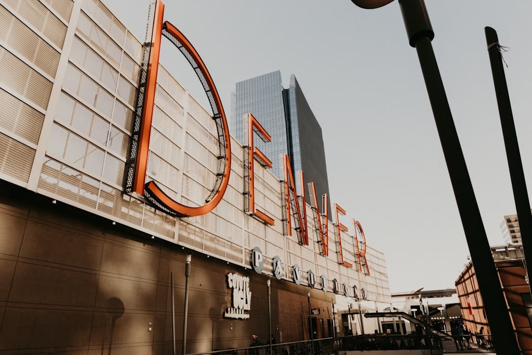 a tall building with a giant sign on it's side — Photo by Benigno Hoyuela on Unsplash
