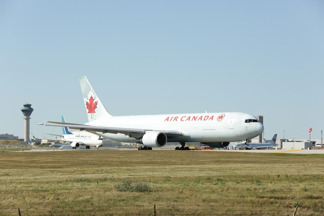 a large air canada jetliner sitting on top of an airport runway — Photo by Michael on Unsplash