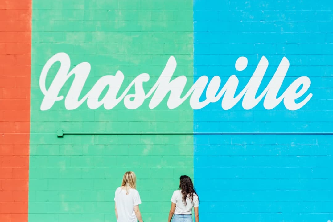 two women facing wall with nashville text — Photo by Katy Anne on Unsplash