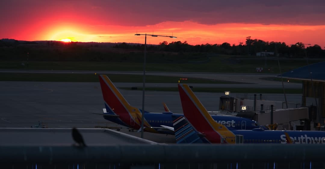 red and blue airplane on airport during sunset — Photo by Wes Smith on Unsplash