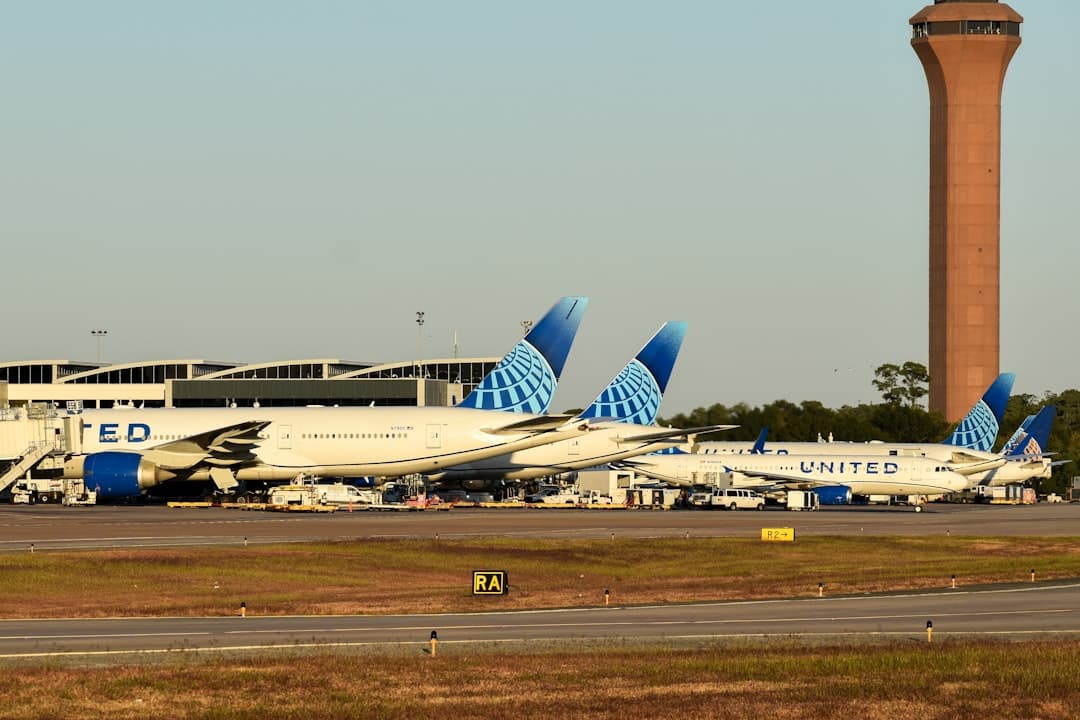 A row of airplanes parked at an airport — Photo by David Syphers on Unsplash
