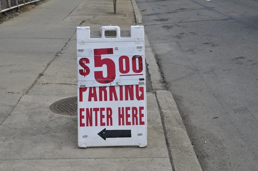white and red no parking sign — Photo by Odd Fellow on Unsplash