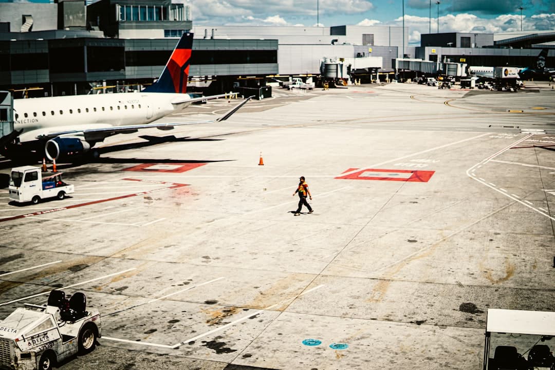 a person walking next to an airplane — Photo by Sean Nufer on Unsplash