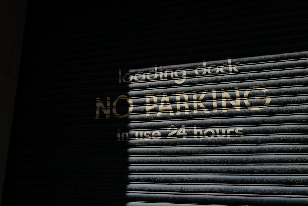 a no parking sign on a closed garage door — Photo by kyle chan on Unsplash