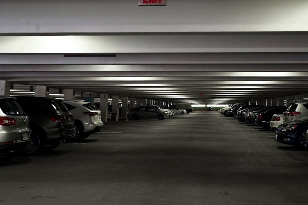 a parking garage filled with lots of parked cars — Photo by Anastasiya Badun on Unsplash