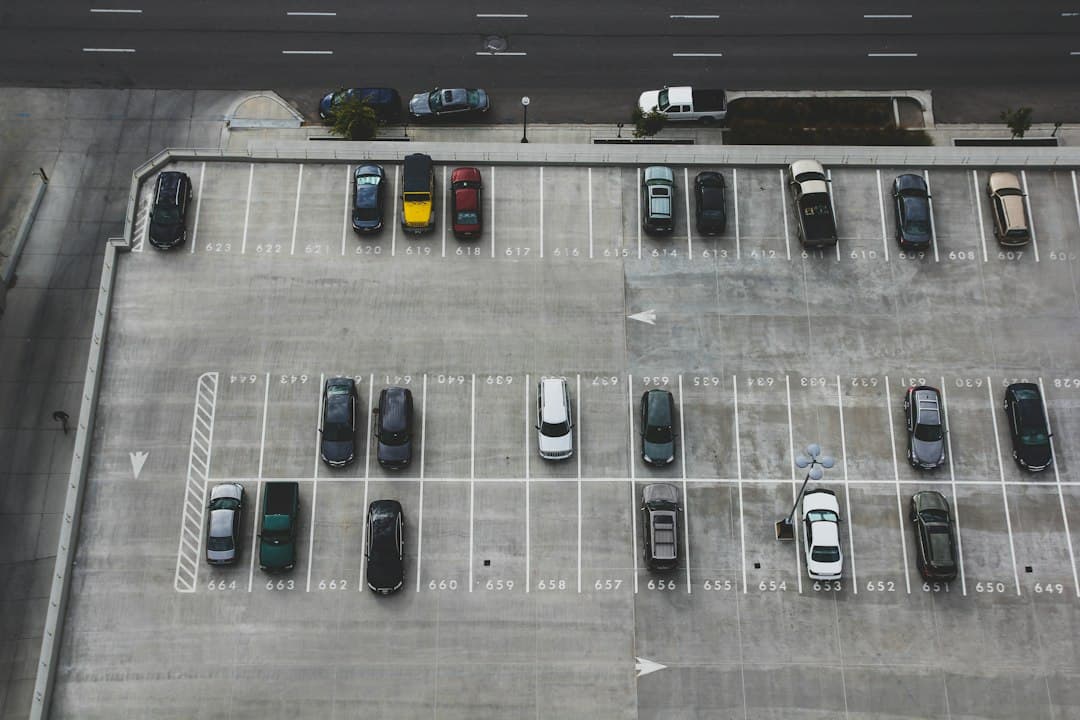aerial view of cars parked on parking lot — Photo by John Matychuk on Unsplash