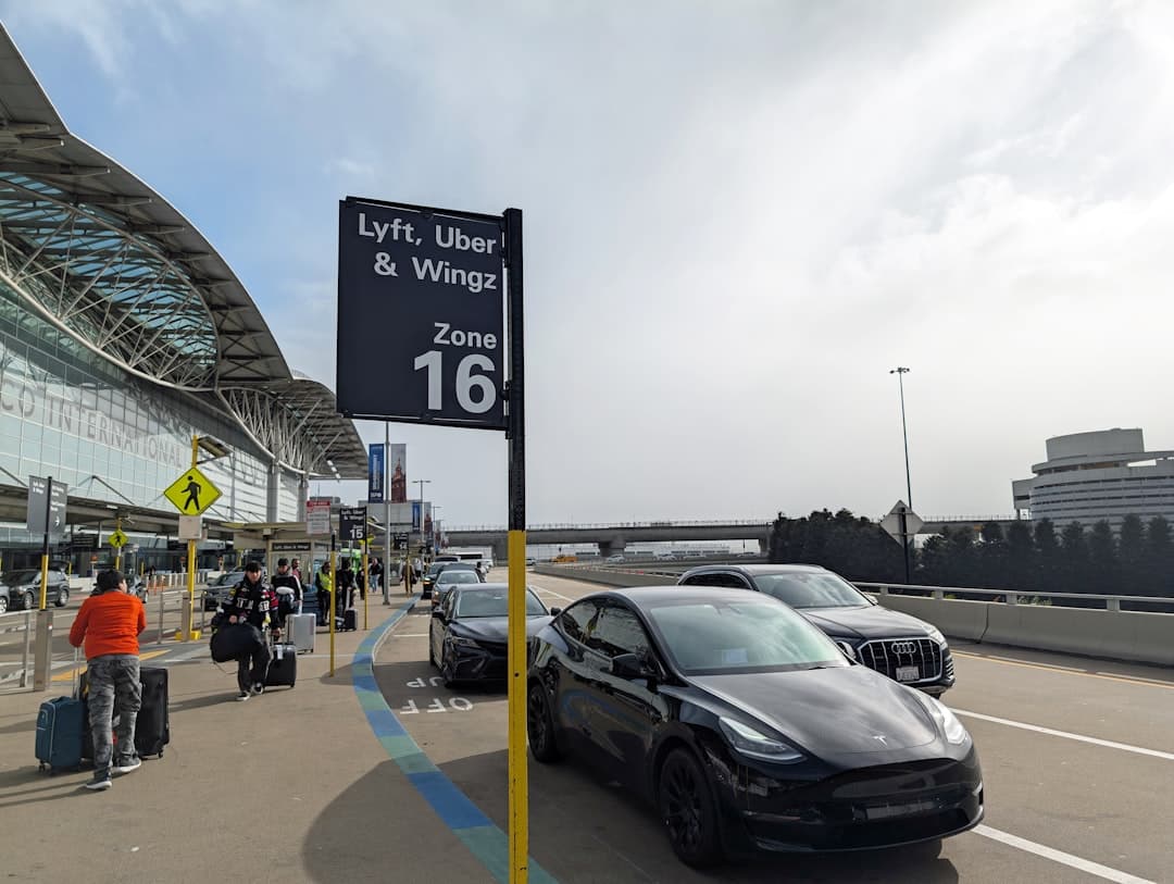 A car parked in front of an airport — Photo by Kenjiro Yagi on Unsplash